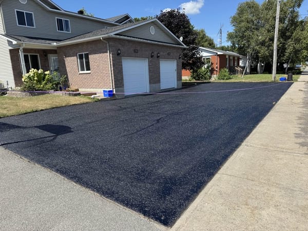 Freshly sealed black asphalt driveway